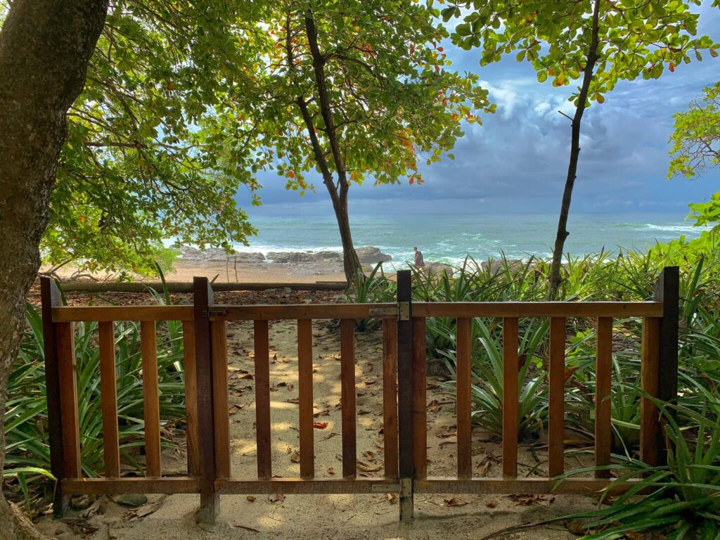 casa amore garden gate that leads to the beach with ocean views