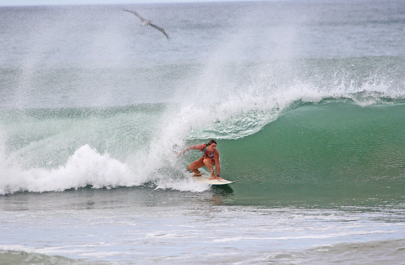 A woman surfing the wave